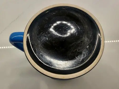 Interior view of a black 3D sculpted Carolina Panthers ceramic coffee mug