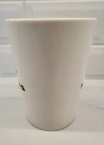 White ceramic coffee mug featuring Baltimore Ravens logo by Duck House