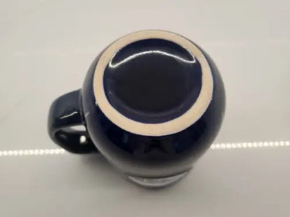 Dark blue ceramic coffee mug featuring Tennessee Titans 3D logo relief design