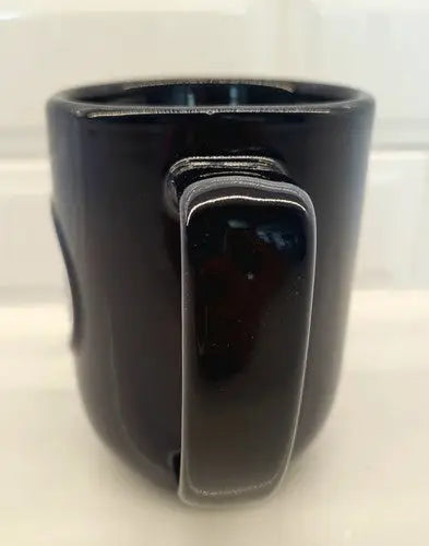 Dark ceramic coffee mug featuring Tennessee Titans 3D logo relief design