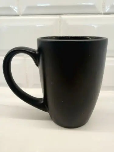 Matte black ceramic coffee mug featuring New York Jets bistro logo for fans
