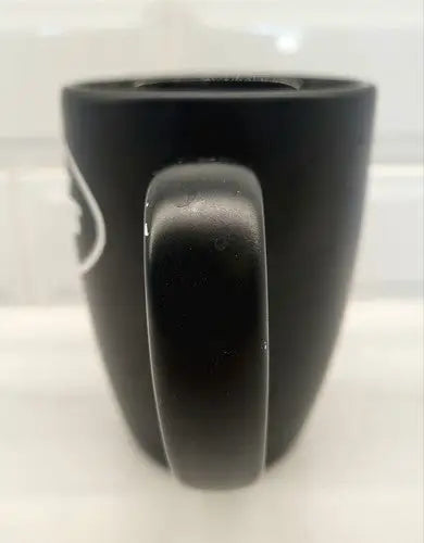 Black ceramic coffee mug featuring York Jets logo, perfect for fans and collectors