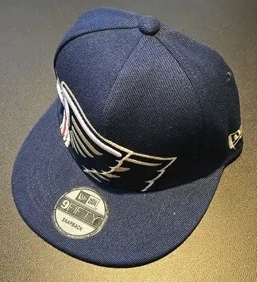 Navy blue Orleans Pelicans baseball cap with wing design and Zion Williamson card
