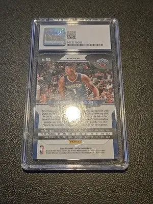 Orleans Pelicans Zion Williamson graded basketball card displayed with New Era hat
