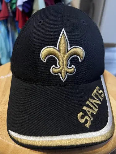 Black New Orleans Saints NFL hat with gold fleur-de-lis emblem and trim