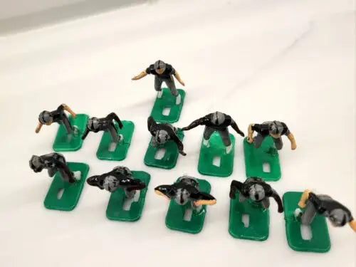 Miniature NFL 1970s football players on green bases for Oakland LA Raiders collectibles
