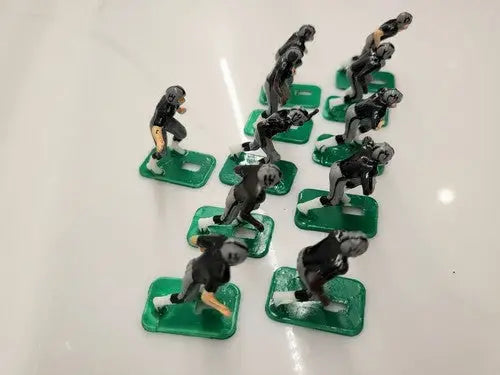 Toy football players from NFL 1970s featuring Oakland LA Raiders in new black paint