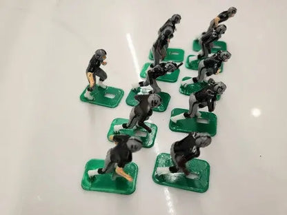 Toy football players from NFL 1970s featuring Oakland LA Raiders in new black paint