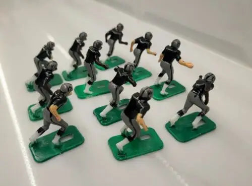 Toy football players featuring NFL 1970s Oakland LA Raiders in new black paint
