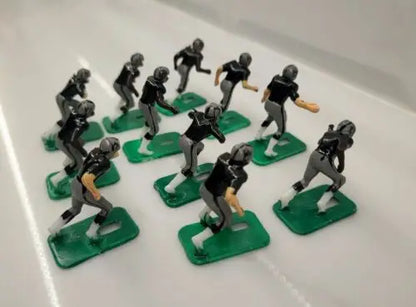 Toy football players featuring NFL 1970s Oakland LA Raiders in new black paint