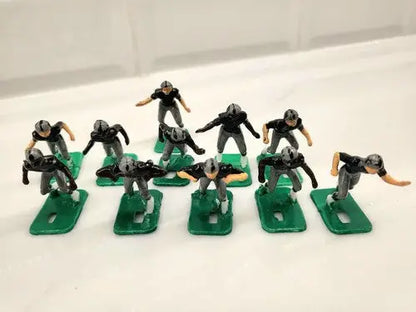 Miniature football player figurines from NFL 1970s Oakland LA Raiders Tudor set