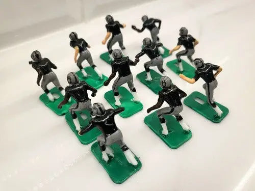 Miniature football player figurines of NFL 1970s Oakland LA Raiders in new black paint