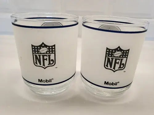 Two NFL Mobil glasses featuring Dallas Cowboys frosted glass helmet logo for fans
