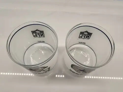 Two clear Dallas Cowboys frosted glass helmet logo drinking glasses for NFL fans