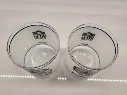 Two clear Dallas Cowboys frosted glass helmet logo drinking glasses for NFL fans
