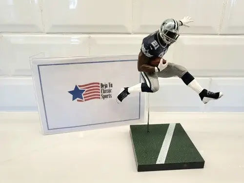Football player figurine displaying NFL Mcfarlane Ezekiel Elliott loose action figure in Dallas Cowboys team colors