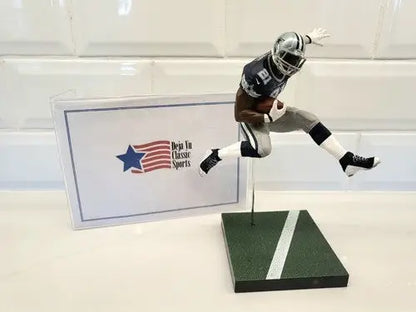 Football player figurine displaying NFL Mcfarlane Ezekiel Elliott loose action figure in Dallas Cowboys team colors