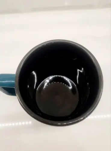 Dark ceramic mug with blue handle, officially licensed Philadelphia Eagles design