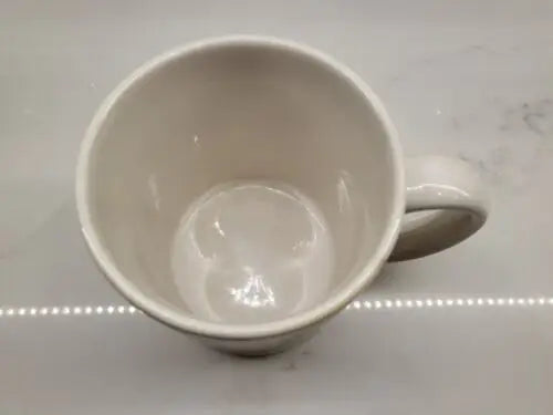 Empty white ceramic coffee mug featuring NFL Signed Tommy McDonald autographed design