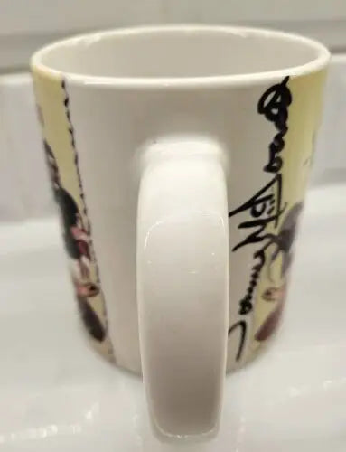 Ceramic coffee mug featuring cartoon design and NFL signed Tommy McDonald autograph