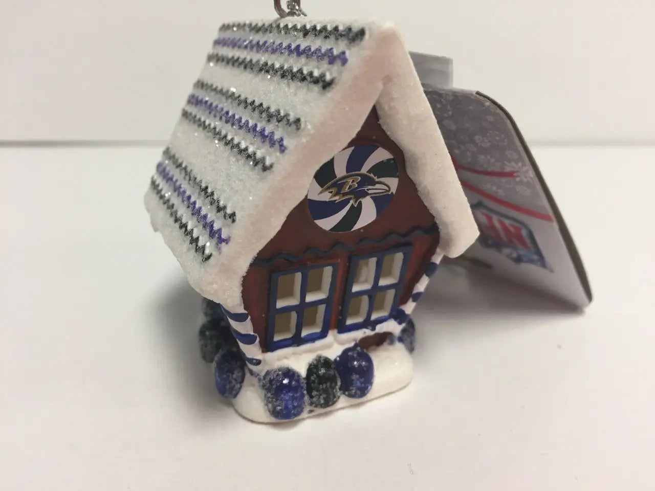 Miniature gingerbread house ornament with purple and white roof for NFL Team collection