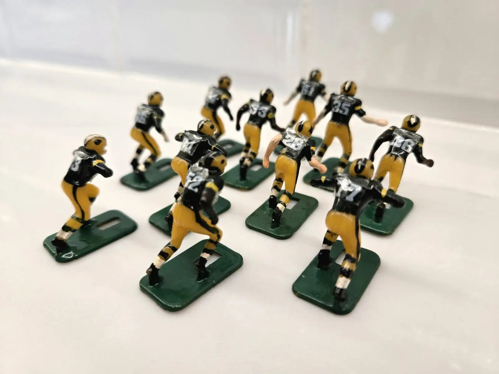 Miniature football player figurines of Green Bay Packers in NFL Vintage Tudor black shoes