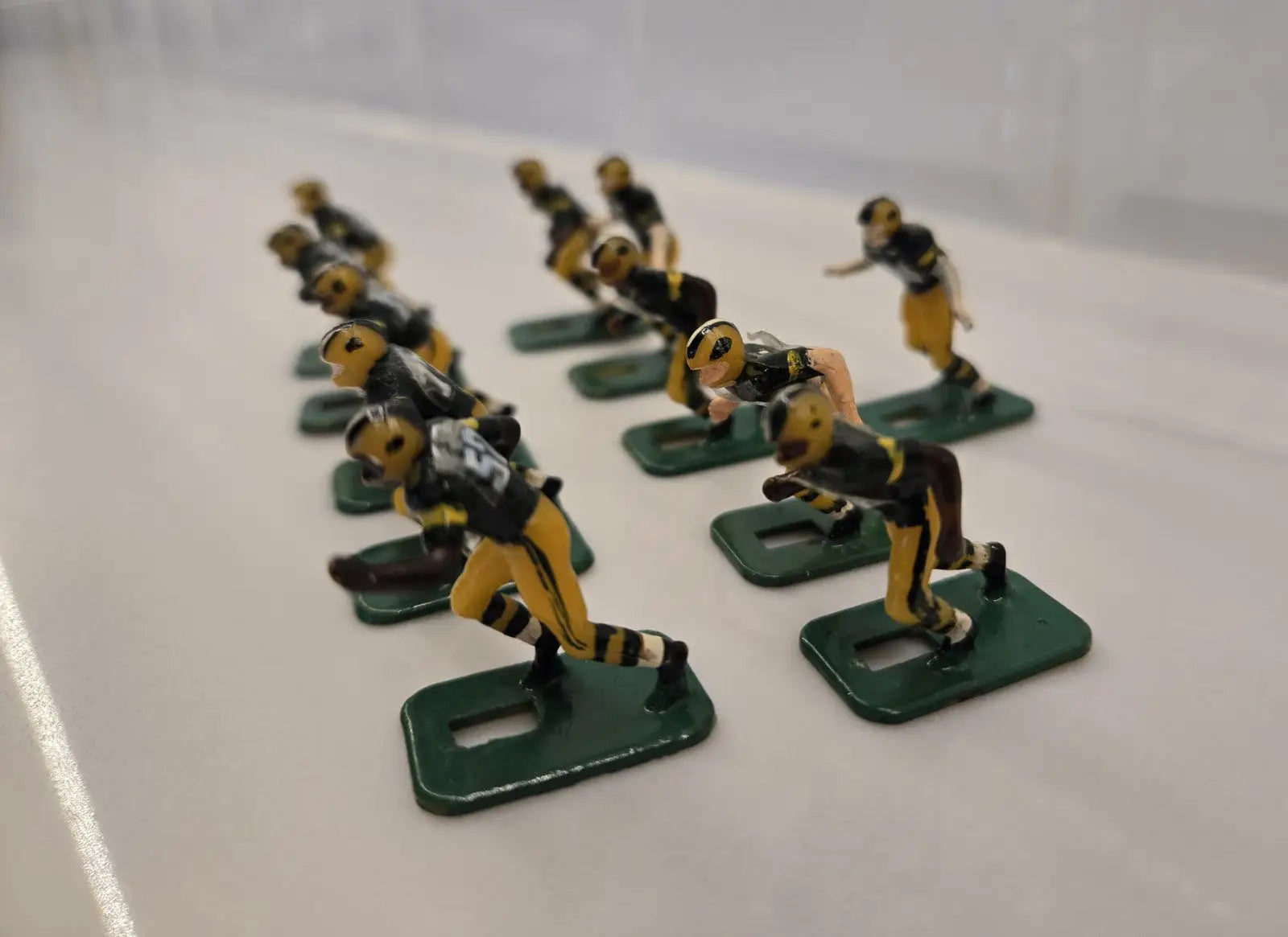 Vintage metal football figurines of Green Bay Packers players in NFL Tudor set