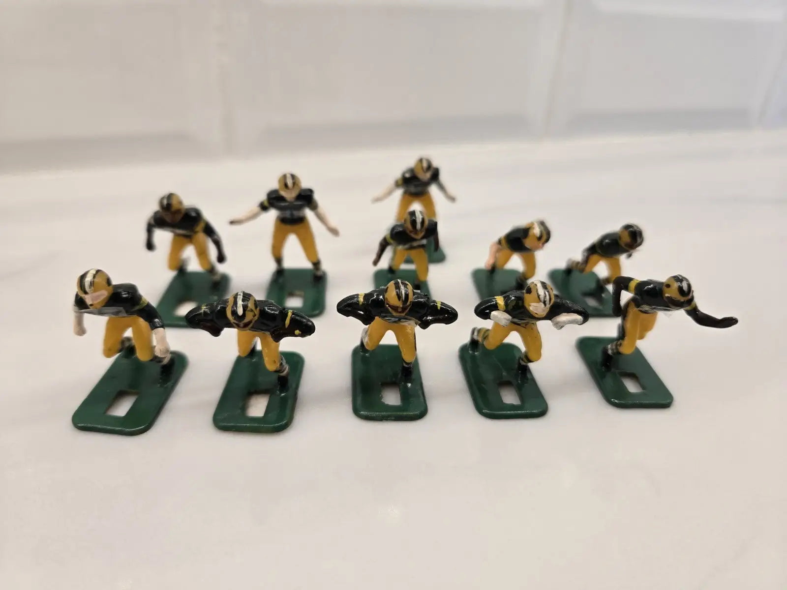 Toy football players representing the Green Bay Packers in NFL Vintage Tudor Black Shoe