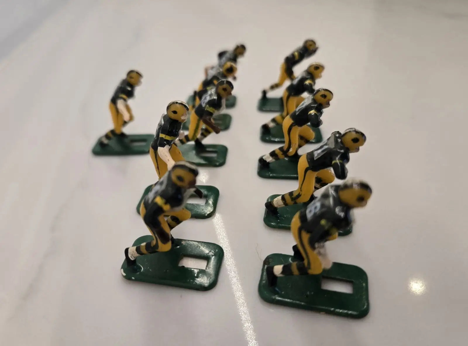 Vintage football player figurines from the Green Bay Packers NFL Tudor set