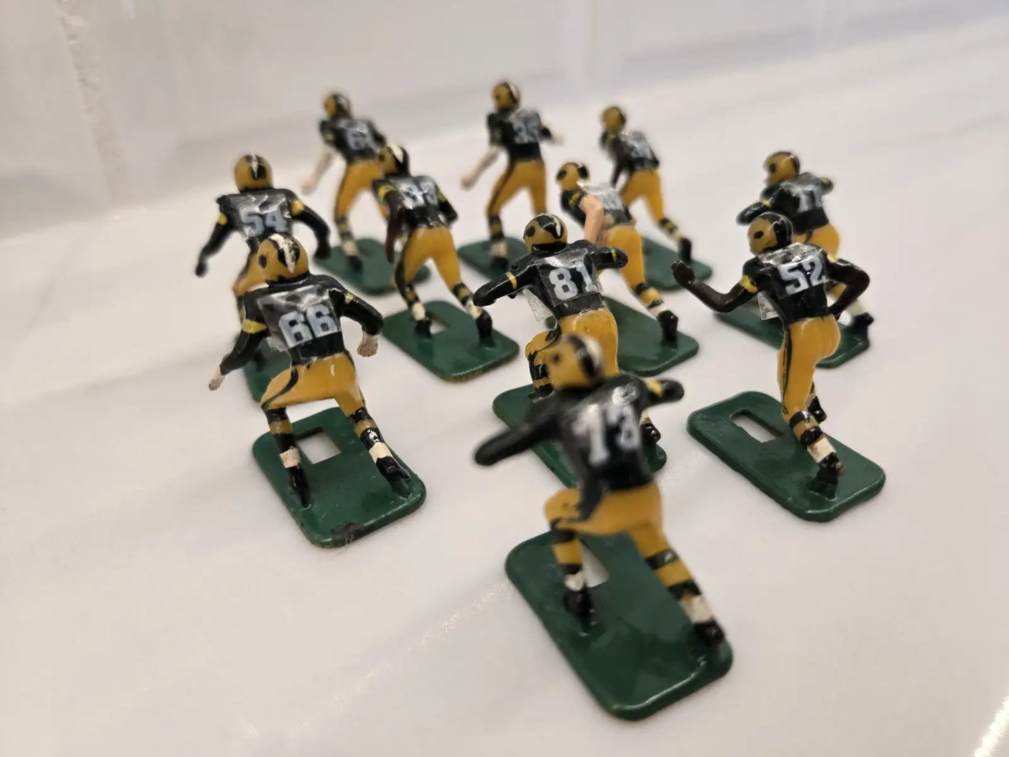 Vintage football figurines of Green Bay Packers in NFL Vintage Tudor Black Shoe display