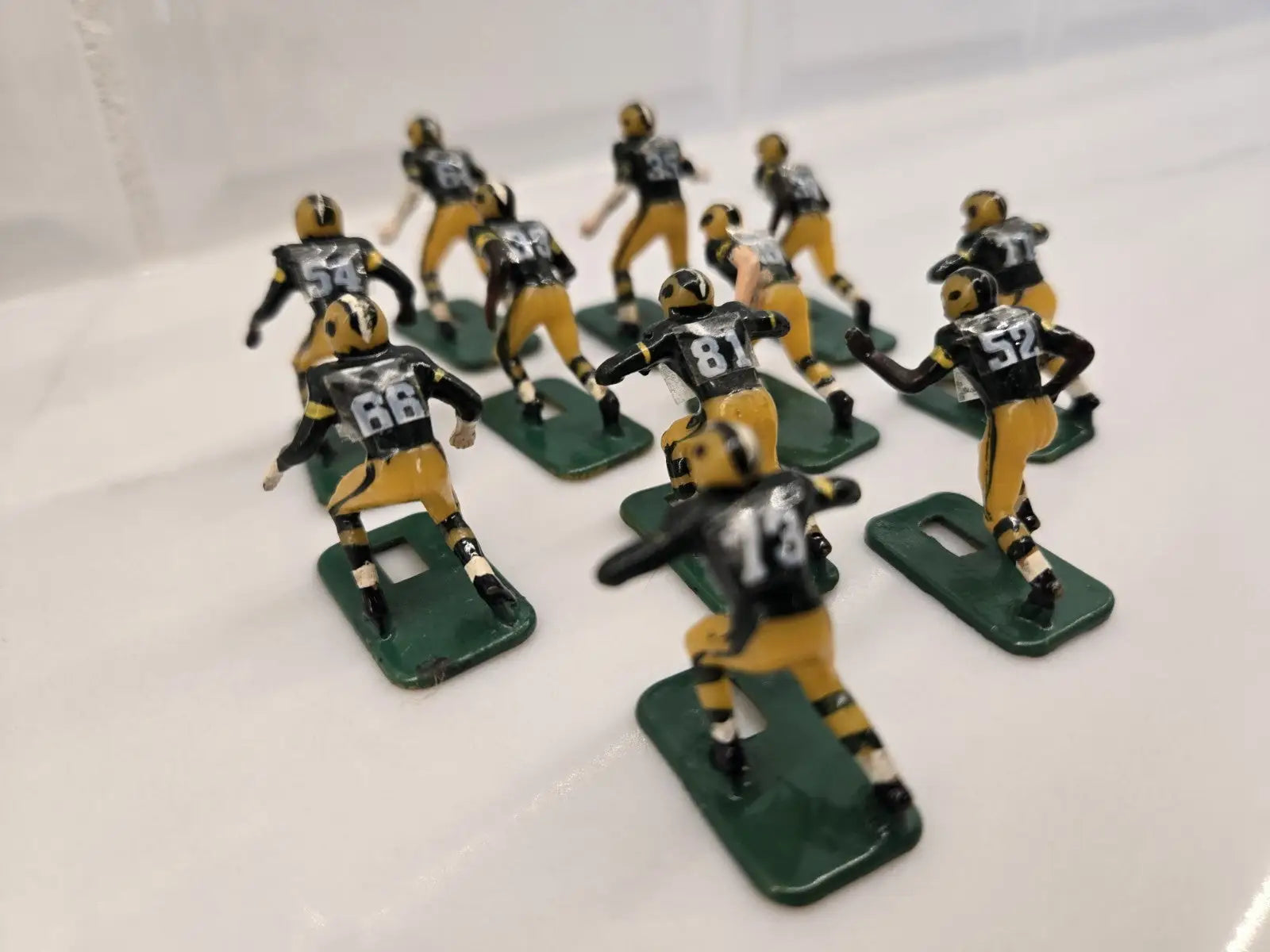 Vintage football figurines of Green Bay Packers in NFL Vintage Tudor Black Shoe display