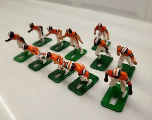 Miniature football players on green bases from Denver Broncos electronic football set