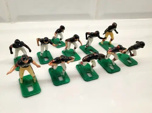 Toy football players on green bases from the Chicago Bears Electronic Football Set