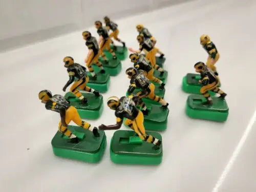 Vintage electric football figures of Green Bay Packers with custom stands for collectors
