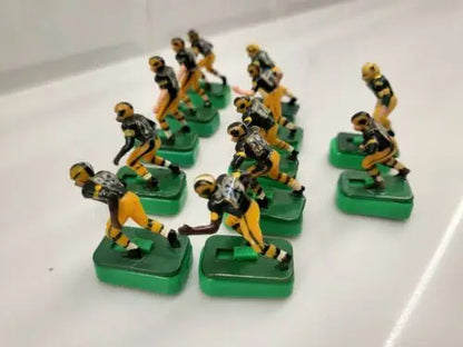 Vintage electric football figures of Green Bay Packers with custom stands for collectors