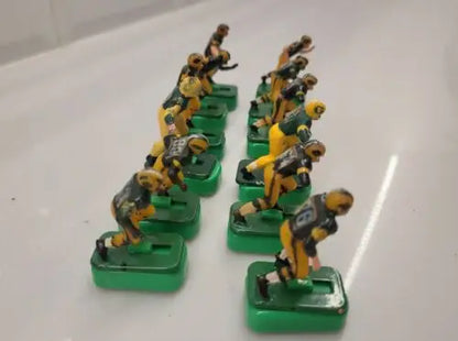 Vintage electric football figures featuring Green Bay Packers players with stands
