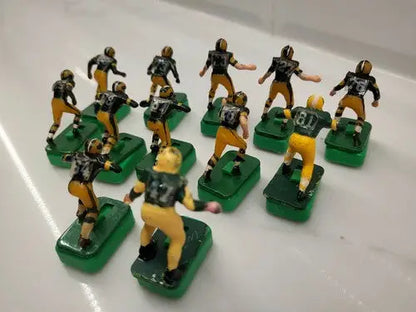 Miniature Green Bay Packers football figures on green bases with custom stands