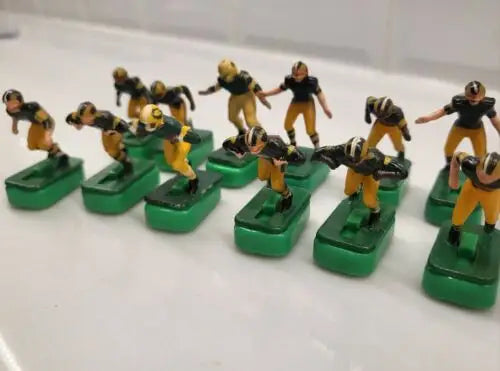 Vintage electric football game figures featuring Green Bay Packers players with stands