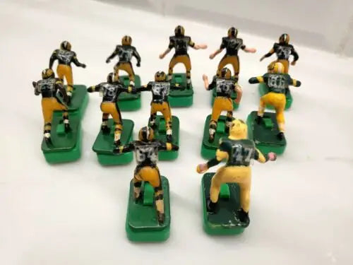 Vintage electric football figures featuring Green Bay Packers players with custom stands