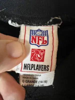 White NFL branding clothing tag with size large and Reggie Bush Football Saints info