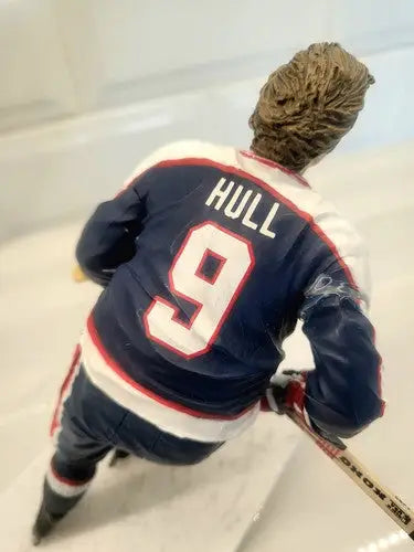 Hockey player figurine of Bobby Hull in NHL Winnipeg Jets blue uniform with repaired arm