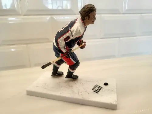 Bobby Hull hockey figurine in blue uniform for NHL Winnipeg Jets with repaired arm