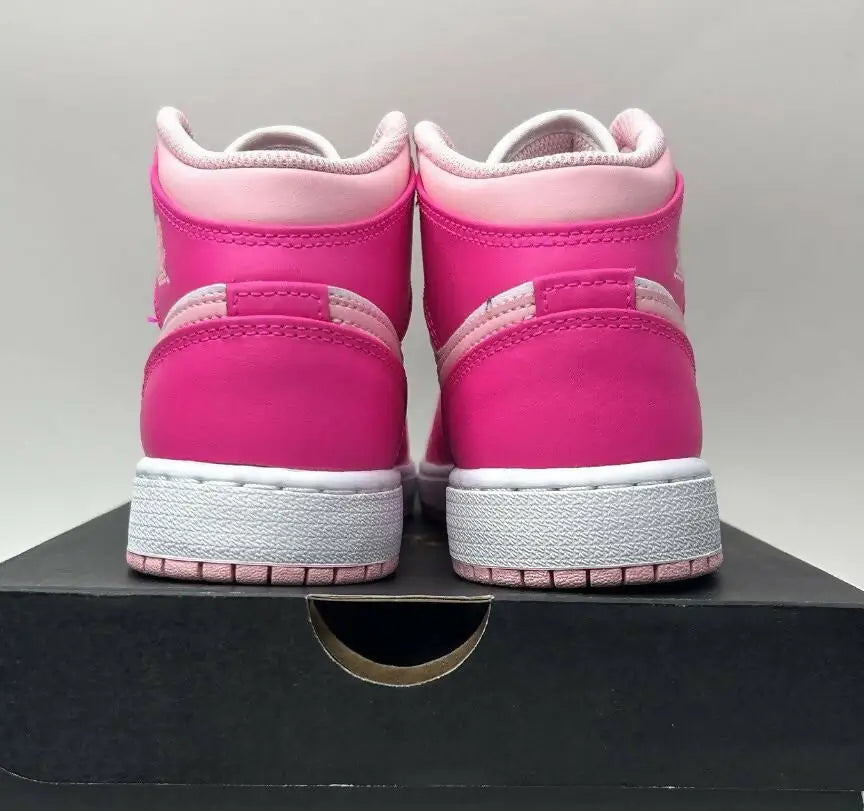 Vibrant pink Nike Air Jordan 1 Retro Mid Fierce Pink Barbie sneakers with white soles
