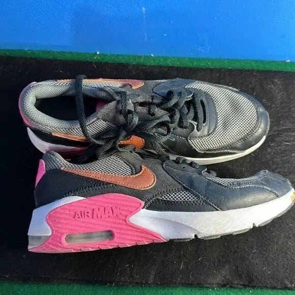 Nike Air Max Excee youth athletic sneakers with black uppers pink soles and copper accents