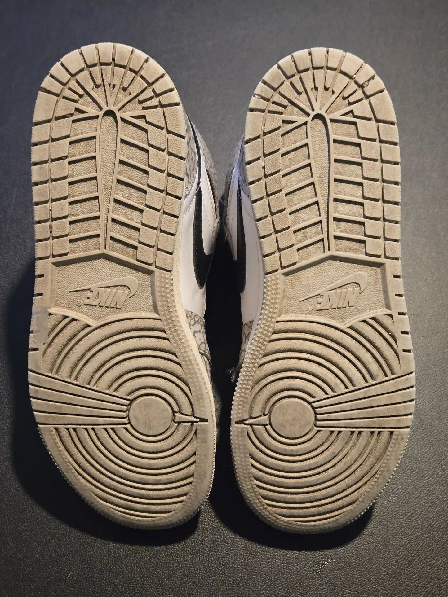 Worn light-colored Nike Jordan Air Leather Shoes Youth 5.5Y with elephant print design