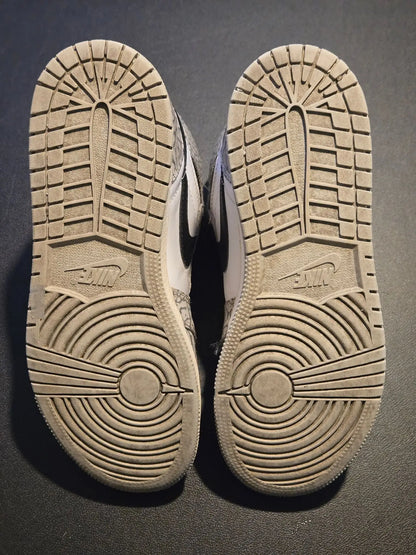 Worn light-colored Nike Jordan Air Leather Shoes Youth 5.5Y with elephant print design