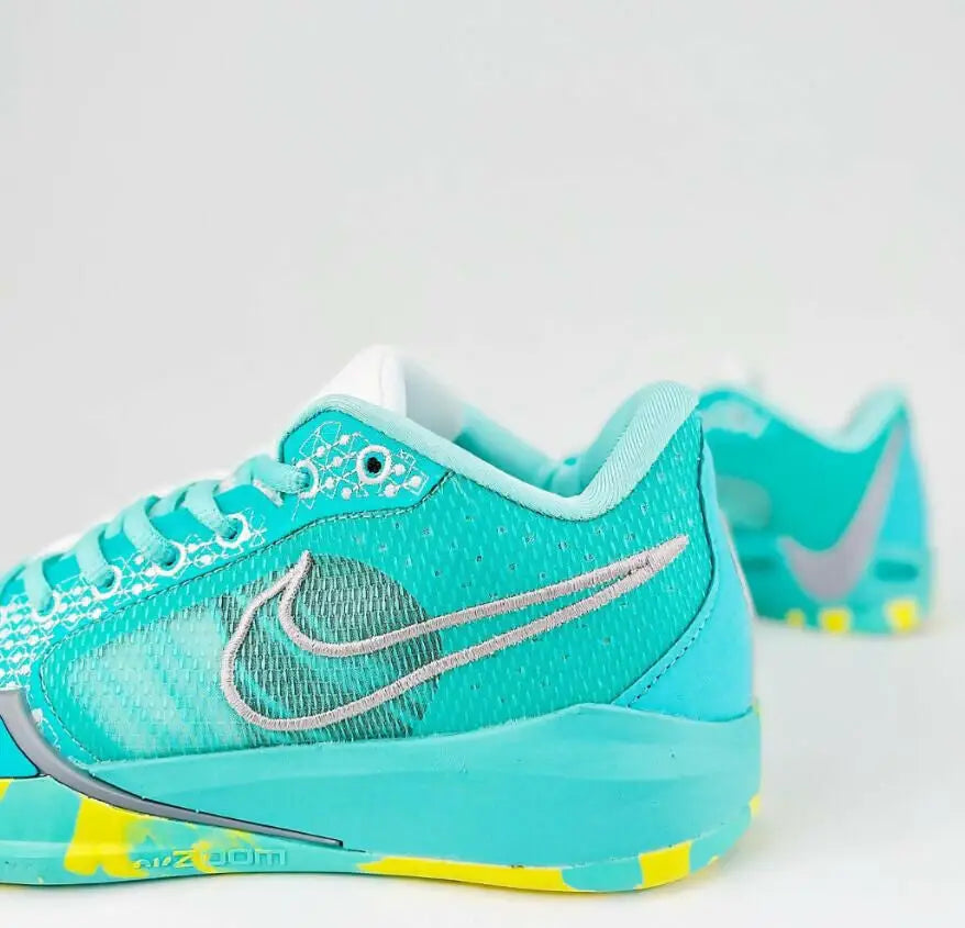 Vibrant turquoise yellow Nike Sabrina 1 Lonescu Ice Blue athletic shoe with grey swoosh