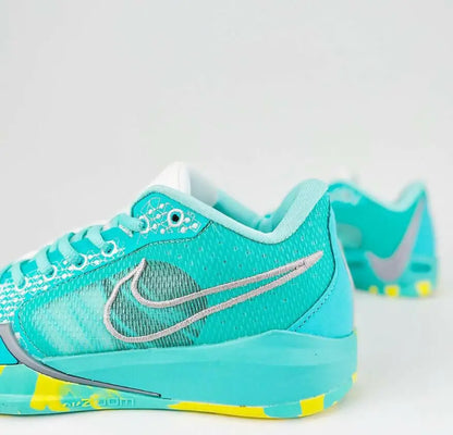 Vibrant turquoise yellow Nike Sabrina 1 Lonescu Ice Blue athletic shoe with grey swoosh