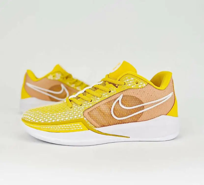 Nike Sabrina 1 Tb University Gold athletic shoes with white soles and swoosh logos