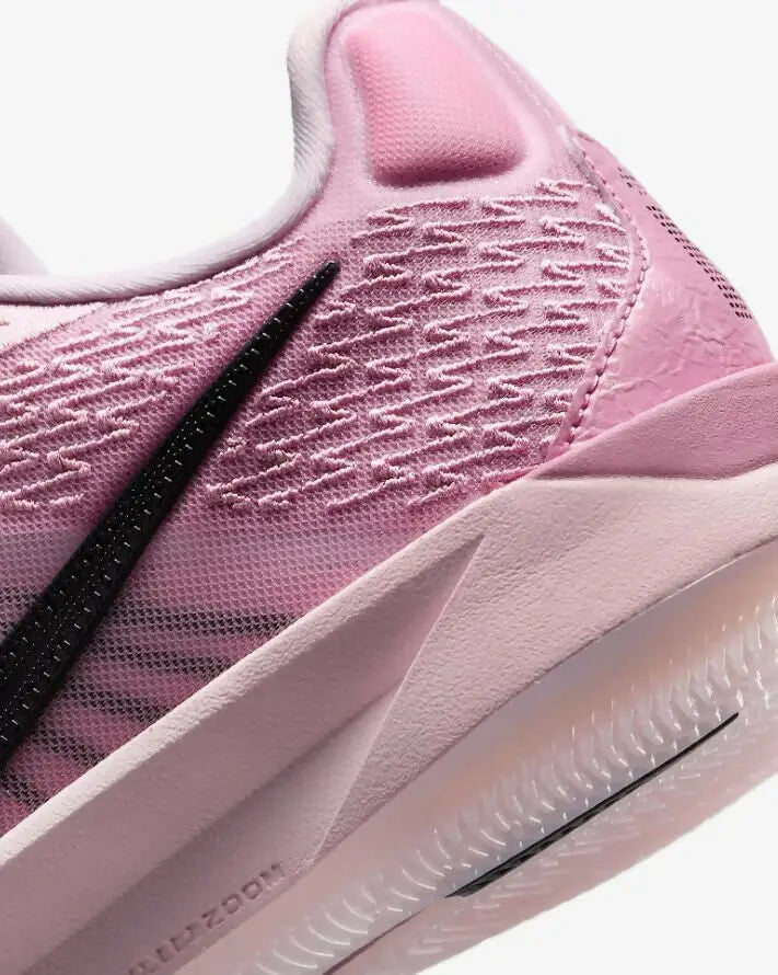 Pink athletic shoe with black Nike Swoosh and textured upper, fast shipping available